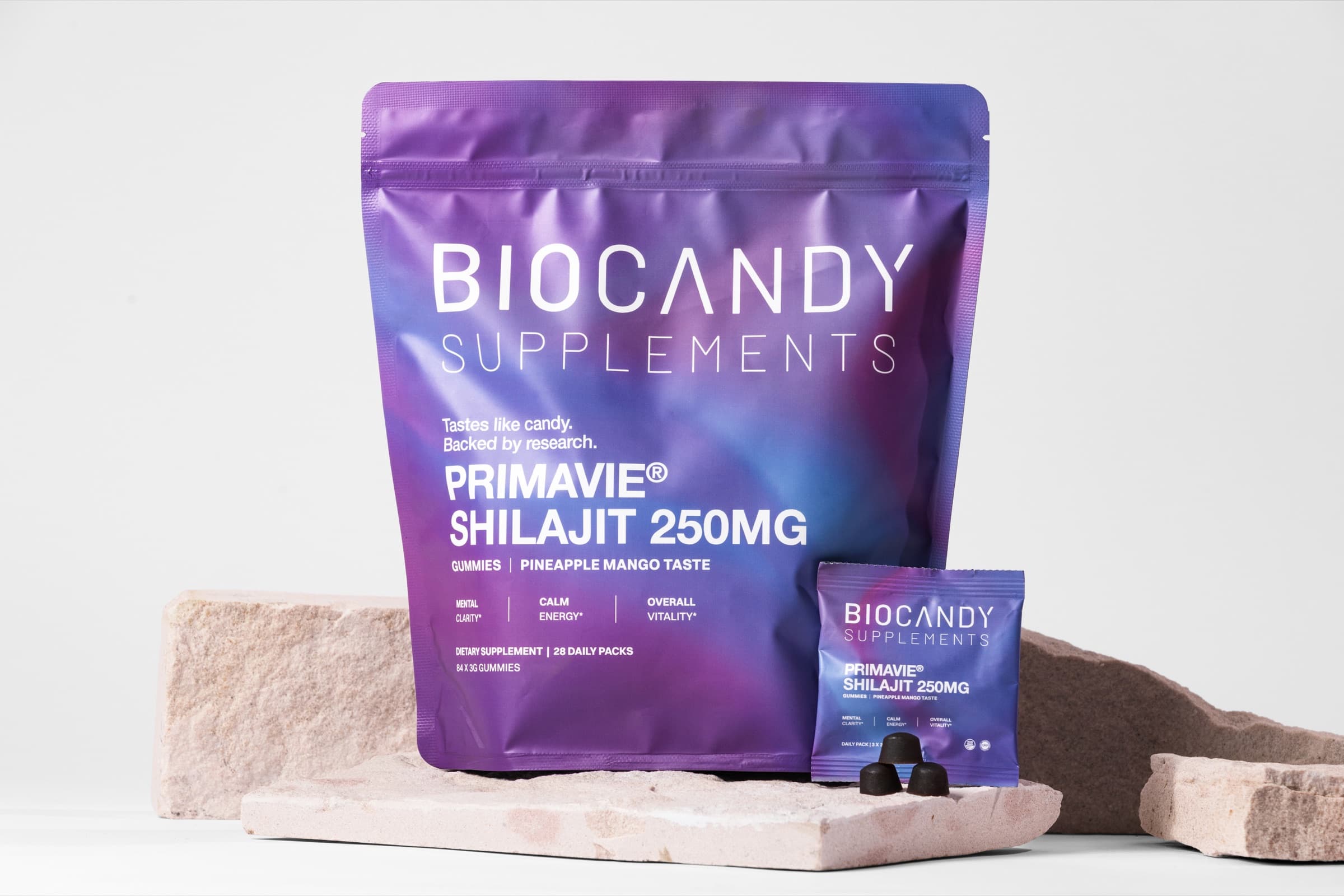 BioCandy PrimaVie Shilajit gummies pouch and daily pack on stone